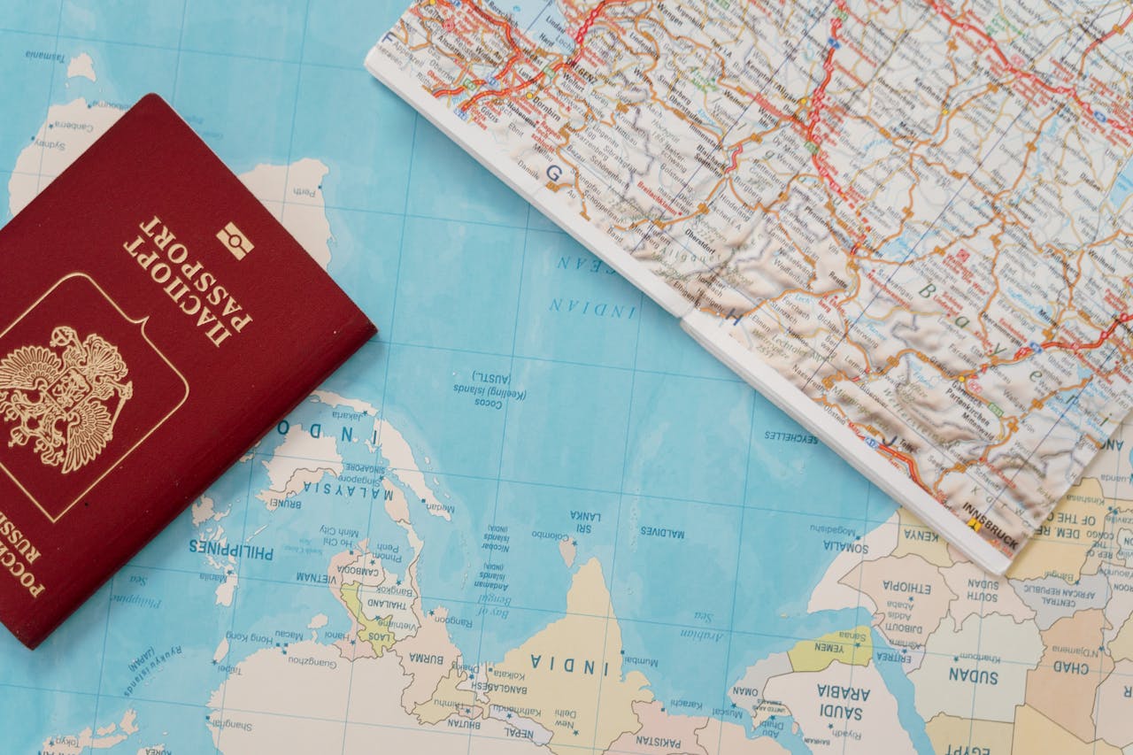 our-services-3 Flat lay of a passport and map, symbolizing travel adventure and exploration.