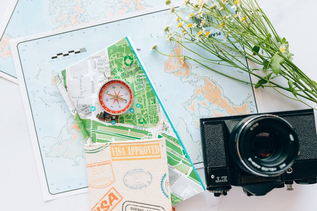 The Art of Drawing Readers In: Your attractive post title goes here Explore your wanderlust with maps, a compass, and a vintage camera.