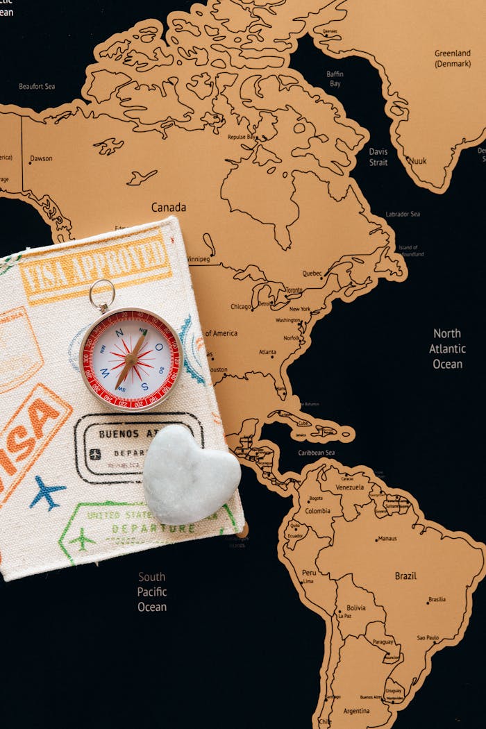 about-01 Flat lay photo of a map, passport, and compass, symbolizing travel and adventure.